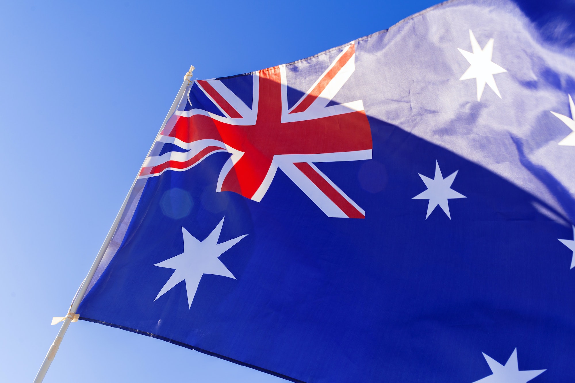 Flag of Australia waving against blue sky